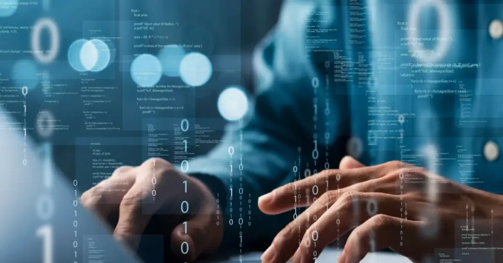 A close-up view of two hands interacting with a futuristic, holographic interface filled with various digital graphics and binary code (0s and 1s). The background is blurred, suggesting an office setting with a person in business attire.
